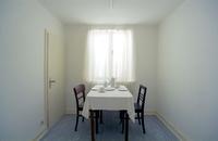 Gregor Schneider, u r 10, (With inventory), KAFFEEZIMMER "Wir sitzen, trinken Kaffee und schauen einfach aus dem Fenster", Rheydt 1993  
Rotating room within a room, plaster boards and chipboards on a wooden construction with posts and wheels, 
1 engine, 2 doors, 1 window, 1 lamp, 1 cupboard, grey wooden floor, white walls and ceiling, detached, 
ca. 35 - 105 cm distance to the outer room, window looking south (246 × 289 x 234 cm (L x W x H), S 1,8 - 35cm), 
HAUS u r, Rheydt, Germany 1985 - today  
© VG Bild-Kunst, Bonn, 2025